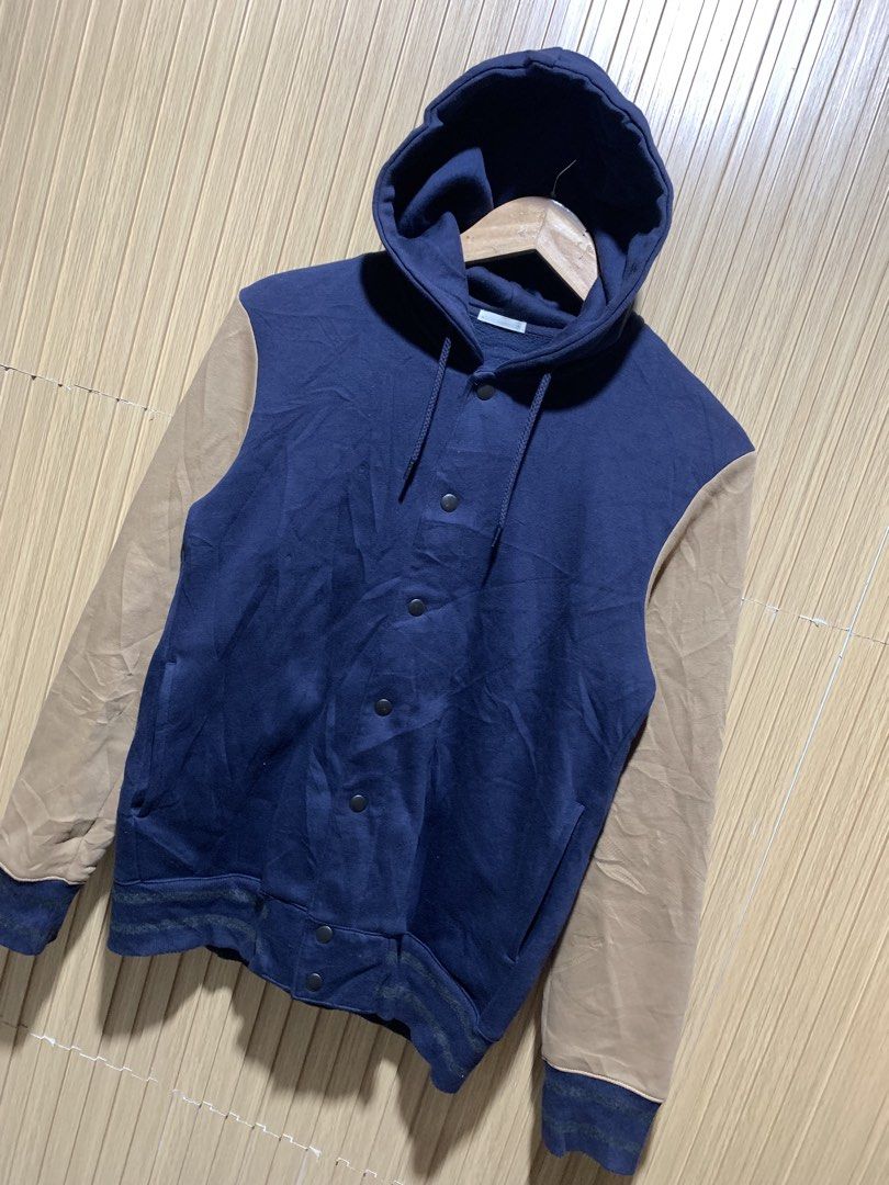 GU Navy and Tan Hooded Varsity Jacket Size M (Category: Coats, Jackets and Outerwear) located in Kidapawan. Submitted by nicnic1_gem (Listing ID 1467719101, Image 2). Description: - Brand: GU - Style: Hooded varsity jacket - Color: Navy blue body with tan sleeves - Size: Medium - Material: Cotton and polyester blend - Closure: Snap button front - Pockets: Two side pockets - Details: Striped ribbed cuffs and hem - Condition: Great for casual wear 