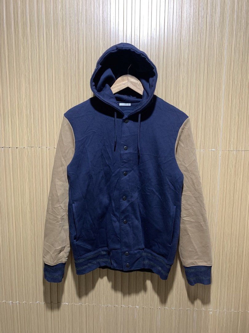 GU Navy and Tan Hooded Varsity Jacket Size M (Category: Coats, Jackets and Outerwear) located in Kidapawan. Submitted by nicnic1_gem (Listing ID 1467719101, Image 1). Description: - Brand: GU - Style: Hooded varsity jacket - Color: Navy blue body with tan sleeves - Size: Medium - Material: Cotton and polyester blend - Closure: Snap button front - Pockets: Two side pockets - Details: Striped ribbed cuffs and hem - Condition: Great for casual wear 