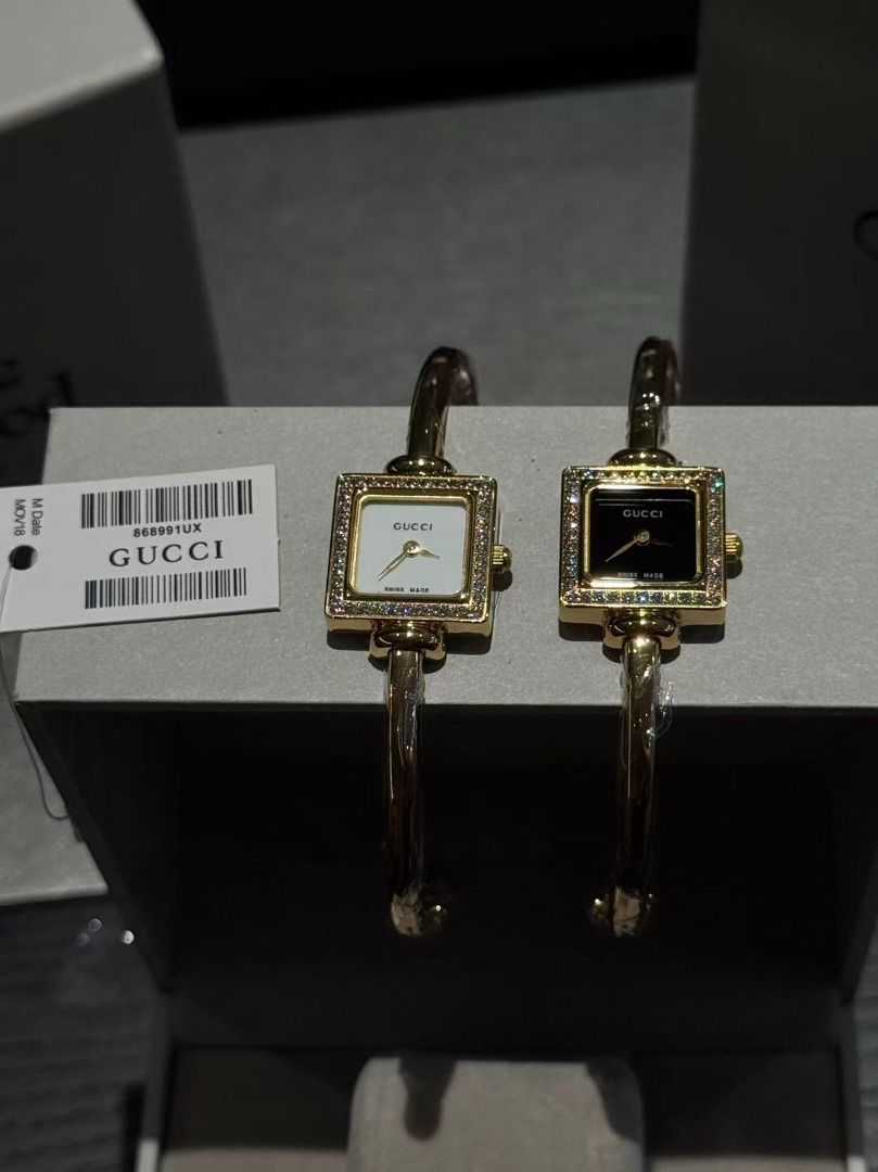 Gucci Bangle Watch with Diamond Bezel (Category: Women's Watches) located in Pateros City. Submitted by purebird_714be0 (Listing ID 1467693449, Image 1). Description: Gucci bangle watch set featuring square bezels encrusted with crystals. Gold-tone hardware with protective plastic wrap still on the cuffs. Multiple dial color options available including white, black, pink, and mother-of-pearl. Swiss made movement. Tag attached with code 868991UX. 