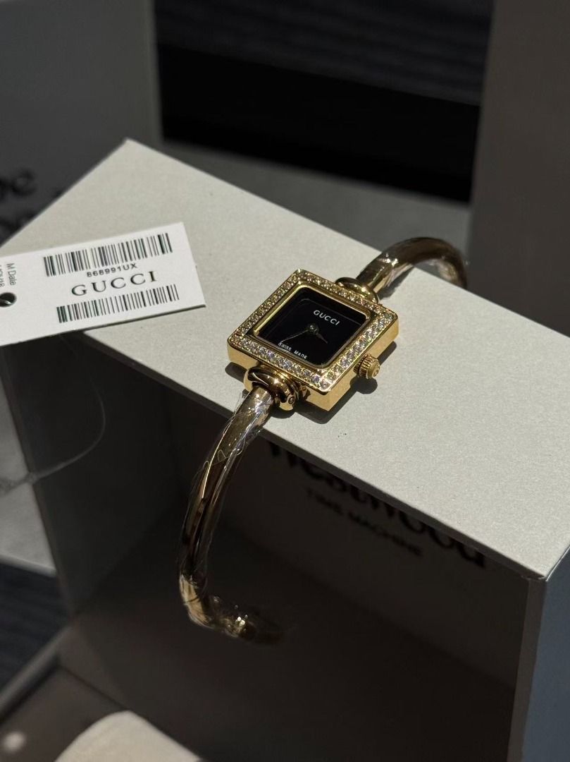Gucci Bangle Watch with Diamond Bezel (Category: Women's Watches) located in Pateros City. Submitted by purebird_714be0 (Listing ID 1467693449, Image 2). Description: Gucci bangle watch set featuring square bezels encrusted with crystals. Gold-tone hardware with protective plastic wrap still on the cuffs. Multiple dial color options available including white, black, pink, and mother-of-pearl. Swiss made movement. Tag attached with code 868991UX. 