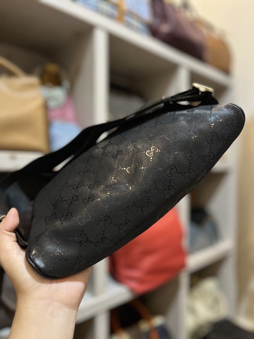 Gucci Black GG Monogram Belt Bag (Category: Luxury Bags & Wallets) located in Bacolod City. Submitted by vintage_vogue6100 (Listing ID 1467762894, Image 3). Description: - Brand: Gucci - Color: Black with all-over monogram pattern - Dimensions: 28cm x 15cm x 6cm - Hardware: Gold-toned with engraved branding on buckle and zipper - Strap: Adjustable nylon strap with metal slider - Details: Leather brand patch on the front.