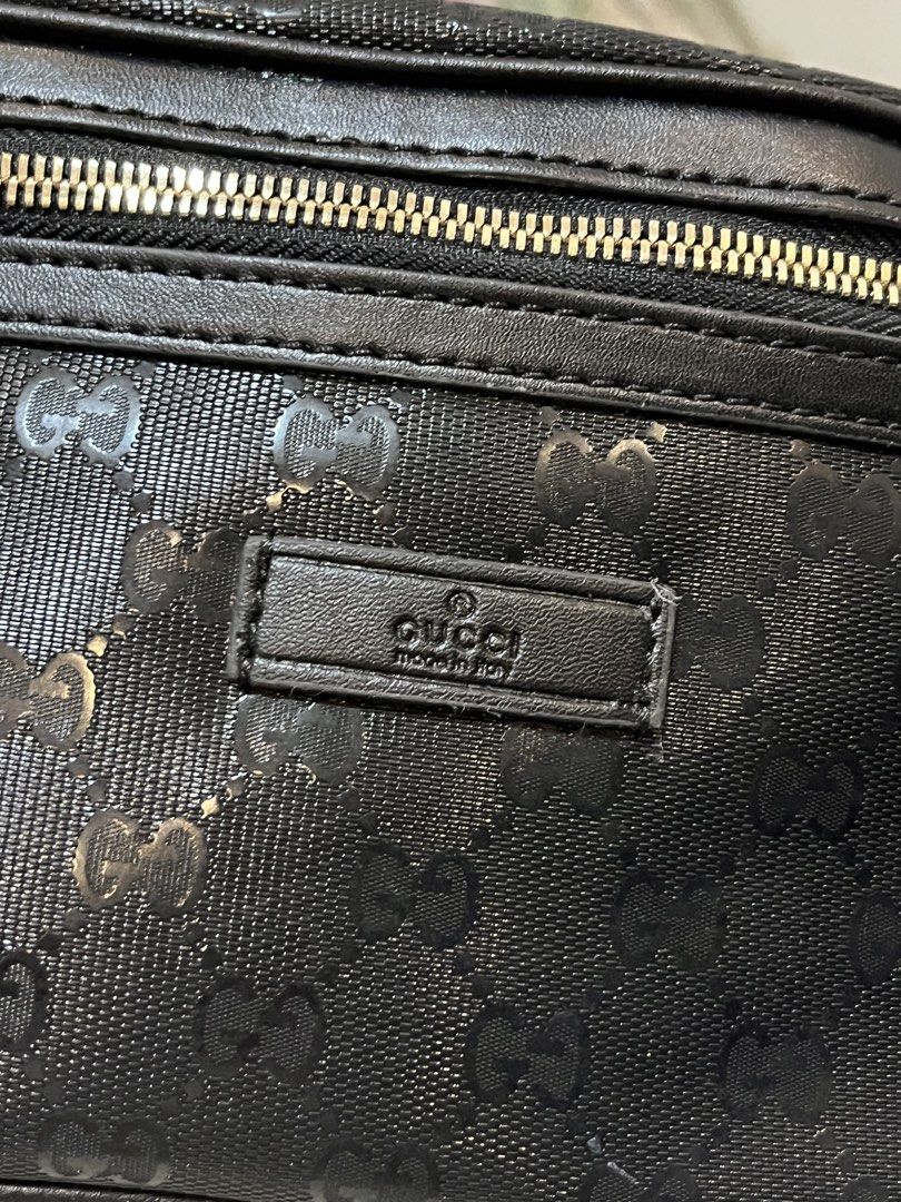 Gucci Black GG Monogram Belt Bag (Category: Luxury Bags & Wallets) located in Bacolod City. Submitted by vintage_vogue6100 (Listing ID 1467762894, Image 2). Description: - Brand: Gucci - Color: Black with all-over monogram pattern - Dimensions: 28cm x 15cm x 6cm - Hardware: Gold-toned with engraved branding on buckle and zipper - Strap: Adjustable nylon strap with metal slider - Details: Leather brand patch on the front.