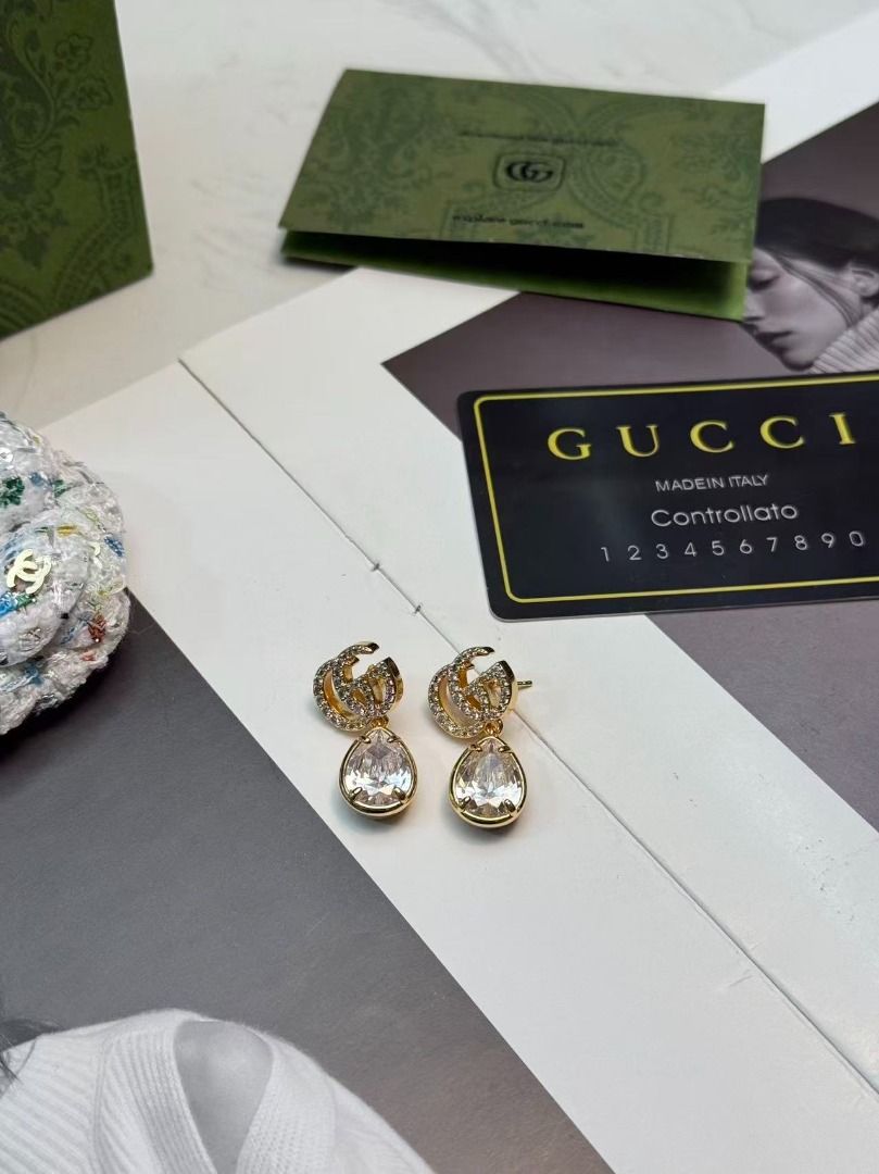Gucci GG Crystal Drop Earrings (Category: Earrings) located in Davao. Submitted by colacodawr20358 (Listing ID 1467687406, Image 2). Description: - Authentic Gucci gold-tone earrings - Features crystal-encrusted Double G logo with dangling large teardrop crystals - Secure post back closure - Hallmarked with Gucci and Made in Italy stamps - Comes complete with green packaging bag and controllato card - Excellent condition, a stunning statement pie