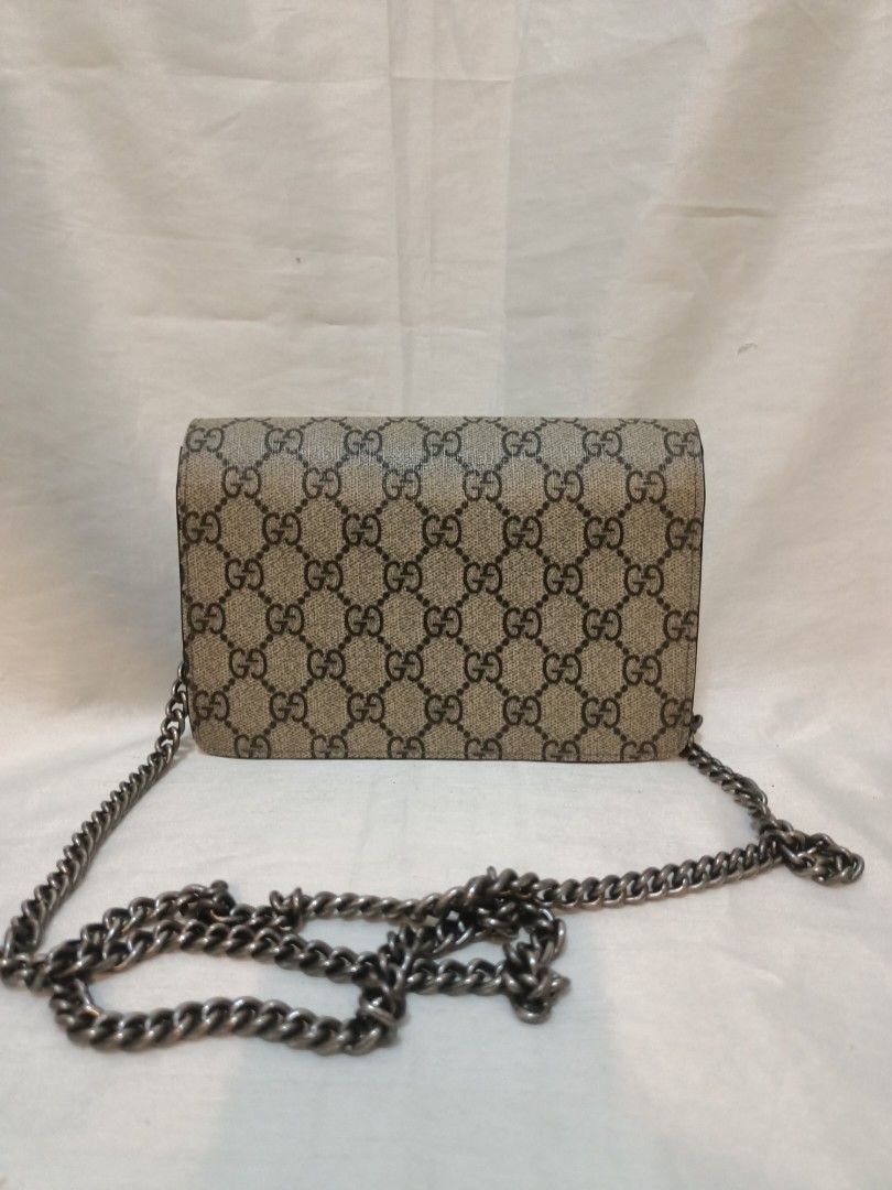 Gucci GG Mini Chain Crossbody Bag (Category: Cross-body Bags) located in Manila. Submitted by preloved439 (Listing ID 1466322880, Image 2). Description: - Gucci mini crossbody bag with classic GG monogram design - Features distinct silver-toned horseshoe closure with tiger head details - Chic black suede and structured side gussets - Includes a sturdy antique-finish metal chain strap - Compact size ideal for essentials and night outs.