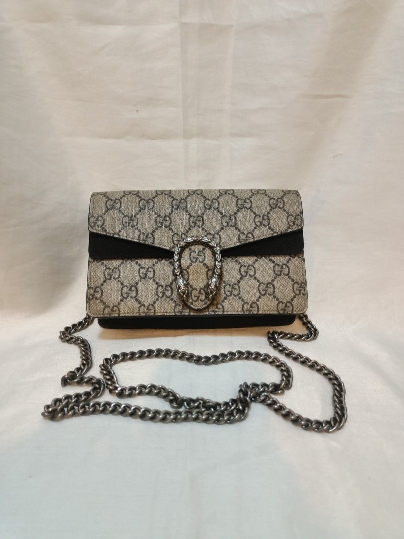 Gucci GG Mini Chain Crossbody Bag (Category: Cross-body Bags) located in Manila. Submitted by preloved439 (Listing ID 1466322880, Image 1). Description: - Gucci mini crossbody bag with classic GG monogram design - Features distinct silver-toned horseshoe closure with tiger head details - Chic black suede and structured side gussets - Includes a sturdy antique-finish metal chain strap - Compact size ideal for essentials and night outs.