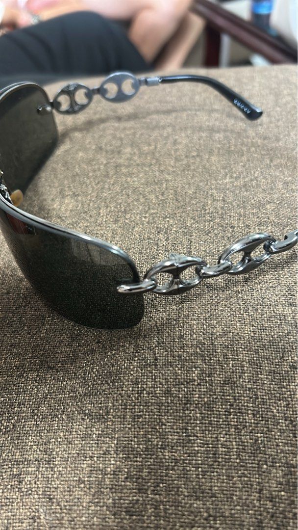 Gucci Shield Sunglasses with Original Case (Category: Sunglasses & Eyewear) located in Cavite. Submitted by florabells (Listing ID 1467676549, Image 2). Description: - Authentic Gucci sunglasses - Sleek oversized wrap-around shape - Dark gradient shield lenses with metal bridge accent - Black frames with inner arm markings - Includes original branded clamshell hard case with gold foil Gucci logo - Perfect statement piece for any accessory collect