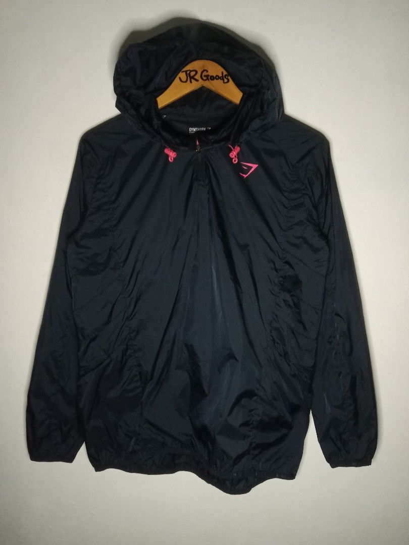 Gymshark Black Windbreaker Jacket Size M (Category: Activewear) located in Tanay. Submitted by jrgoods (Listing ID 1467661559, Image 1). Description: Gymshark windbreaker Medium Dimes: 21/26 Good as new condition 999+ship Tanay Rizal location Shipping Nationwide - Item: Pullover windbreaker jacket - Color: Black with vibrant bright pink accents Medium tag printed inside collar - Material: 100nylon shell - Features: Quarter zip front, attached hoo