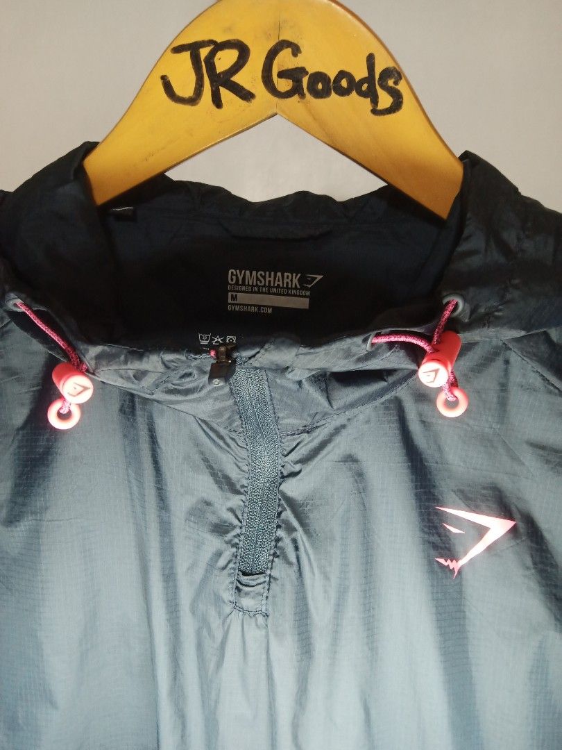 Gymshark Black Windbreaker Jacket Size M (Category: Activewear) located in Tanay. Submitted by jrgoods (Listing ID 1467661559, Image 2). Description: Gymshark windbreaker Medium Dimes: 21/26 Good as new condition 999+ship Tanay Rizal location Shipping Nationwide - Item: Pullover windbreaker jacket - Color: Black with vibrant bright pink accents Medium tag printed inside collar - Material: 100nylon shell - Features: Quarter zip front, attached hoo