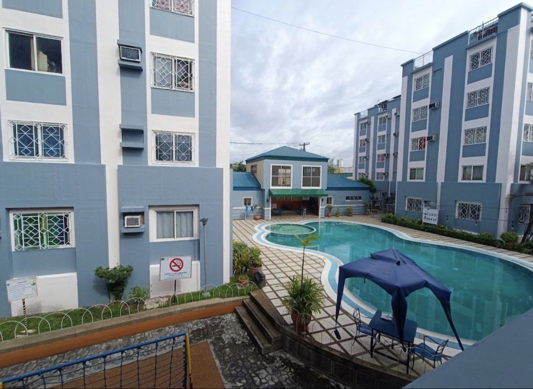 Hampstead Gardens Condominium Property with Pool and Amenities (Category: Apartments & Condos) located in Manila. Submitted by tineemall (Listing ID 1467711607, Image 2). Description: Dues included - Location: Hampstead Gardens - Environment: Peaceful, quiet neighborhood surrounded by trees and paved walkways - Amenities: Outdoor swimming pool and children's playground - Security: Gated entrance with 24/7 security - Property Type: Multi-story res