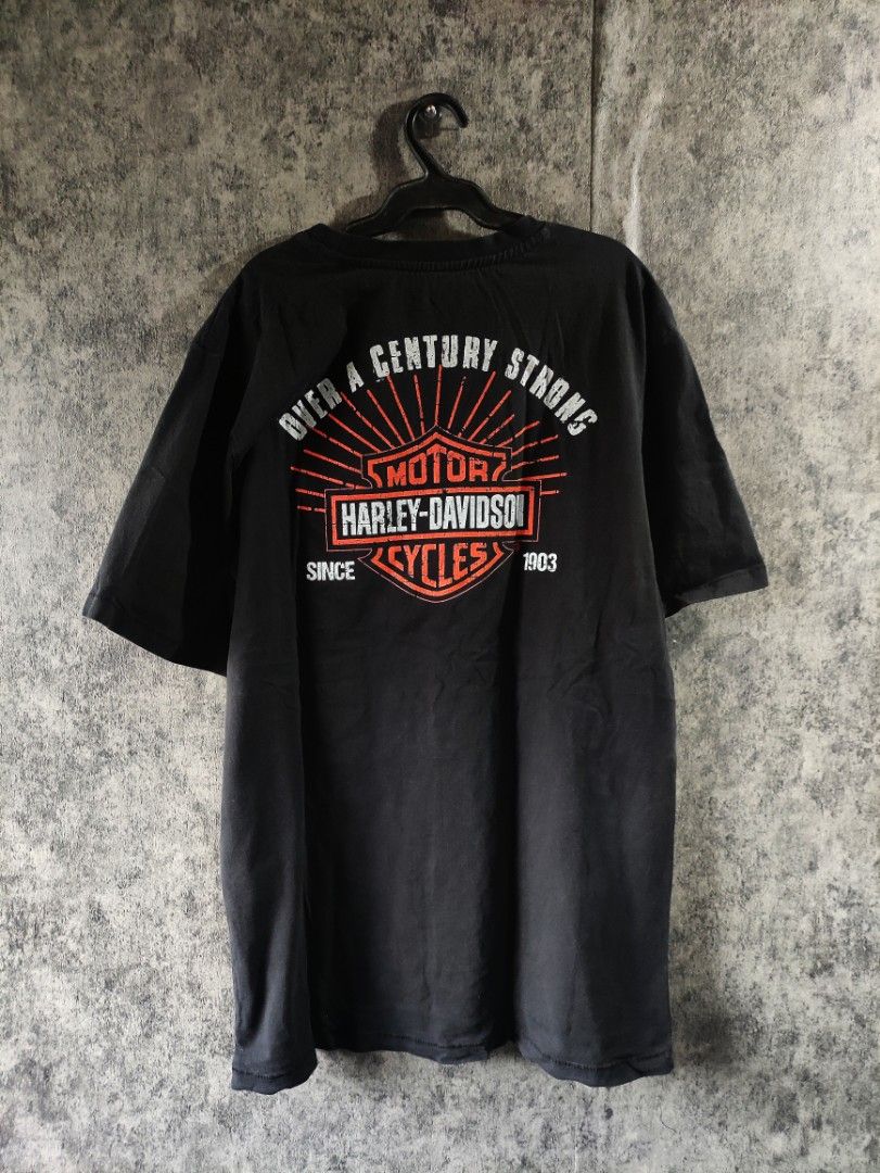 Harley-Davidson Eagle Graphic T-Shirt Black Size L (Category: Tshirts & Polo Shirts ) located in Quezon City. Submitted by lexthrift (Listing ID 1467688974, Image 2). Description: - Brand: Harley-Davidson - Color: Black - Size: L (Relaxed fit) - Material: 100% Cotton - Design: Large eagle graphic with '1903' on chest and 'Over A Century Strong' on the back - Origin: Made in China - Condition: Perfect for casual everyday wear.