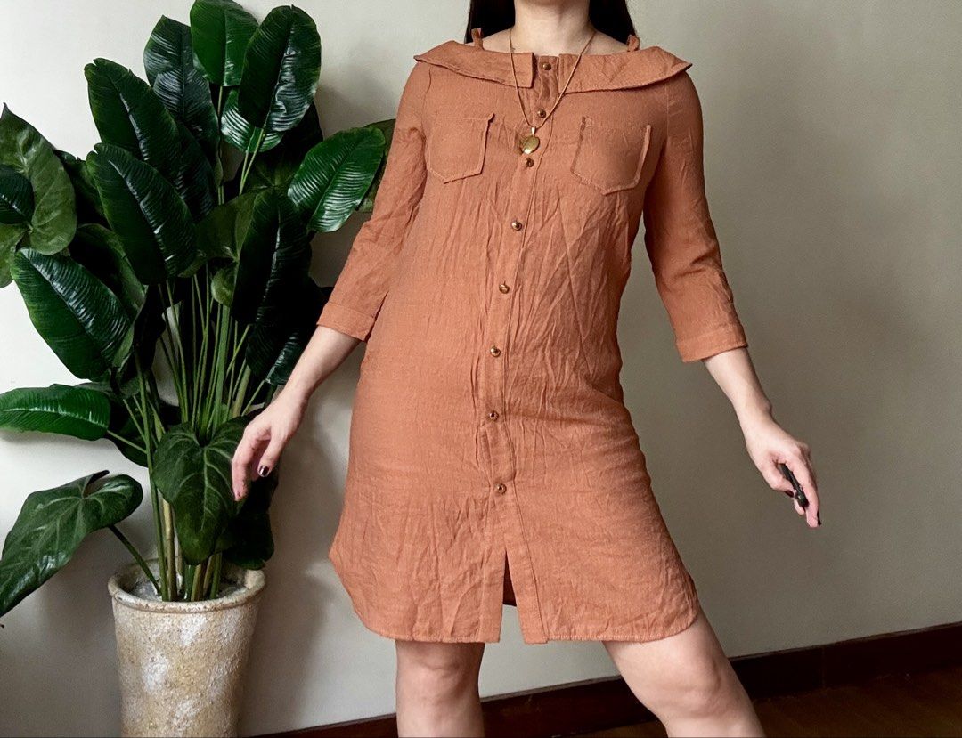 HAYNA Orange Brown Sailor Collar Button Down Dress (Category: Dresses) located in Mandaluyong City. Submitted by roxieeeeeee (Listing ID 1467661415, Image 1). Description: - Color: Orange brown - Style: Button-down dress with a classic sailor collar neckline - Sleeves: Three-quarter sleeves - Pockets: Two chest patch pockets with flaps - Closure: Front button closure with chic metallic buttons - Length: Hits above the knee - Fabric: Mid-weight wi