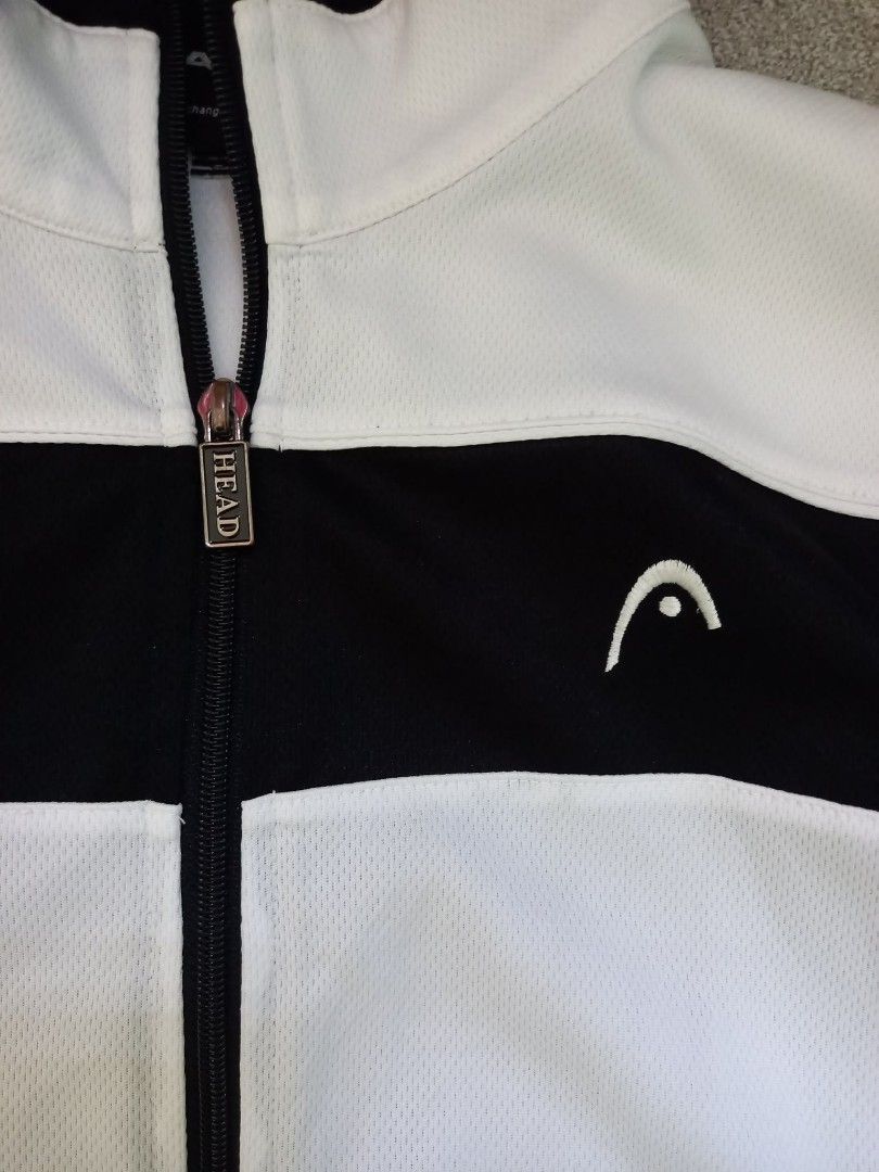 HEAD das Original seit 1950 Track Jacket Size 100 (Category: Coats, Jackets and Outerwear) located in Panabo. Submitted by khimmyirish_ki021126 (Listing ID 1467692592, Image 2). Description: - Brand: HEAD - Style: Track jacket with full zip front and branded metal pull - Color: Black and white with red stripes on sleeves and collar - Details: Embroidered HEAD logo and 'das Original seit 1950' text on chest - Material: Lightweight athletic mesh - 
