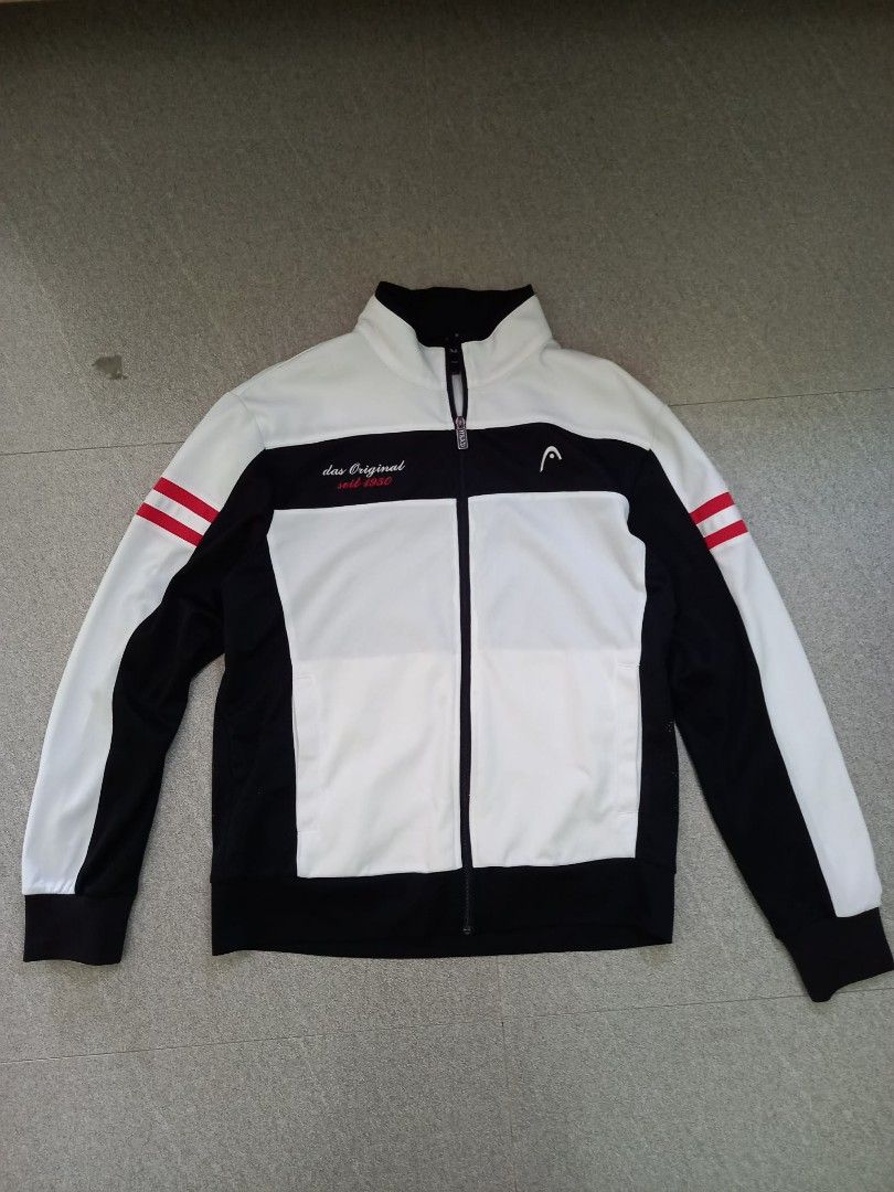 HEAD das Original seit 1950 Track Jacket Size 100 (Category: Coats, Jackets and Outerwear) located in Panabo. Submitted by khimmyirish_ki021126 (Listing ID 1467692592, Image 1). Description: - Brand: HEAD - Style: Track jacket with full zip front and branded metal pull - Color: Black and white with red stripes on sleeves and collar - Details: Embroidered HEAD logo and 'das Original seit 1950' text on chest - Material: Lightweight athletic mesh - 