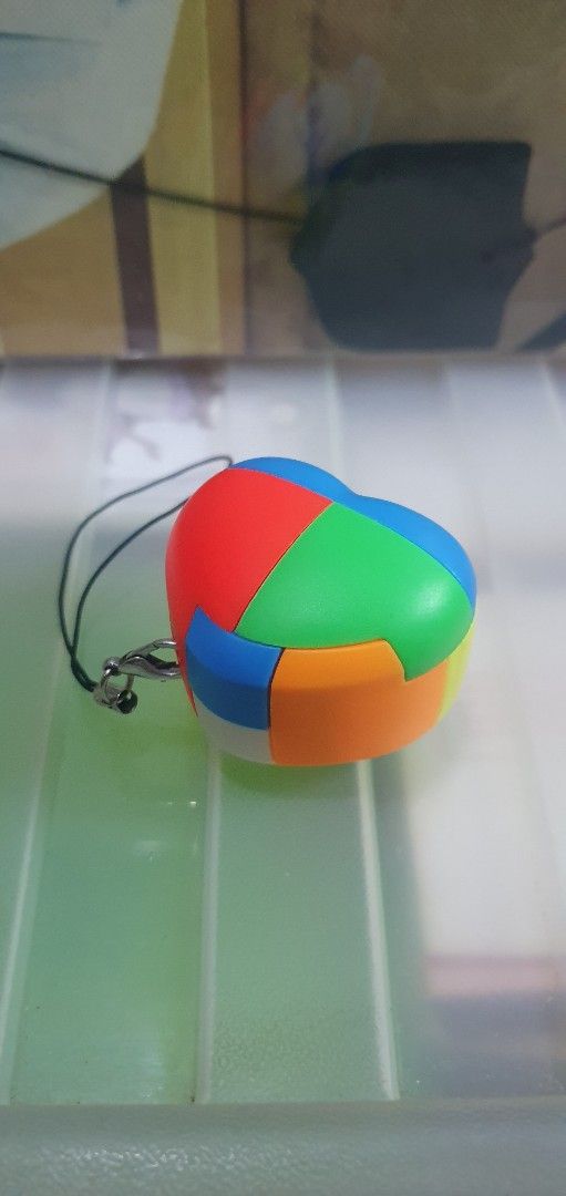 Heart Luban Lock Puzzle Keychain (Category: Board Games & Puzzles) located in Quezon City. Submitted by collectionneursonline88 (Listing ID 1467812660, Image 1). Description: - Adorable heart-shaped design with vibrant multi-colored panels (red, green, blue, orange, yellow) - Smooth and easy rotation for a satisfying fidget and brain teaser experience - Comes with a secure black strap and metal clasp - Perfect size to use as a keychain or bag cha
