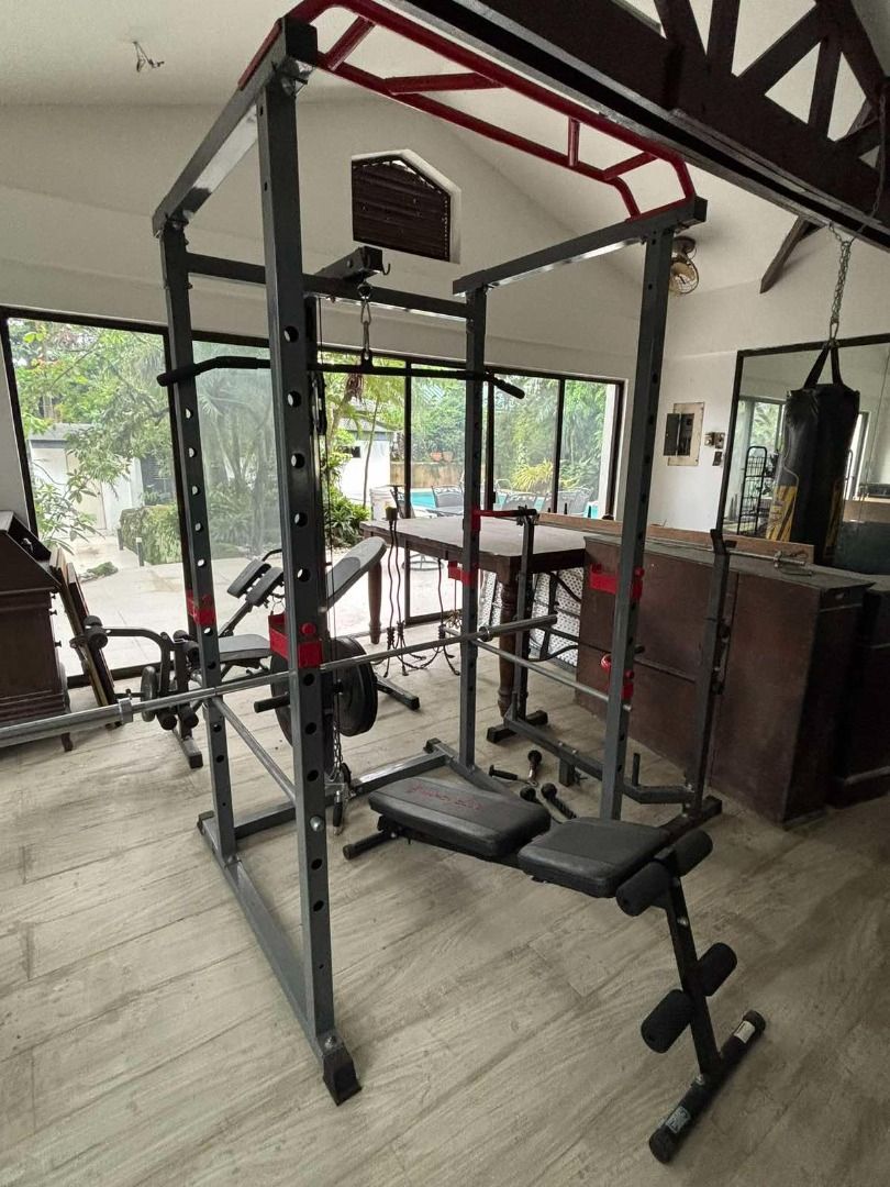 Heavy Duty Power Cage / Power Rack with Lat Pulldown, Dip Handles & Adjustable Bench (Category: Cardio & Fitness Machines) located in Taytay. Submitted by airamgarcia (Listing ID 1467698876, Image 1). Description: Description: Complete home gym setup featuring a full power cage with integrated high-lat pulldown and low-row cable pulley attachments, multi-grip pull-up bar, adjustable J-hooks, safety spotter arms, dip handles, and plate storage peg