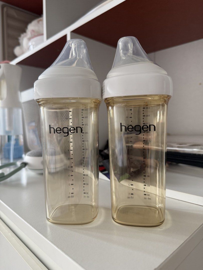 Hegen PCTO 330ml Feeding Bottles Pair (Category: Breastfeeding & Bottle Feeding) located in Manila. Submitted by vetyy1229 (Listing ID 1467644550, Image 1). Description: - Set of 2 Hegen feeding bottles - 330ml capacity each - Durable PPSU material (amber-tinted) - Comes with white screw caps and integrated nipples - Unique square-round design prevents rolling - Clear measurement markings on the side - Excellent, clean condition and ready for use