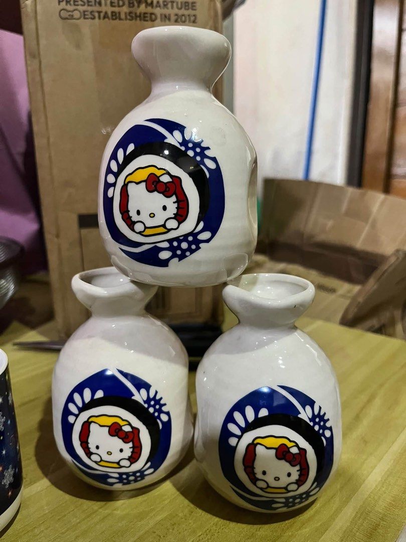 Hello Kitty ceramic sake bottle tokkuri japanese set (Category: Pitchers & Dispensers) located in Manila. Submitted by janetecson05 (Listing ID 1467626239, Image 1). Description: - Official Kitty ceramic sake bottle (tokkuri) with Sanrio stamp on the bottom - Features a charming blue and white sushi graphic design - Traditional narrow-neck shape - Great collectible for Kitty and Sanrio fans - Multiple pieces available for purchase.