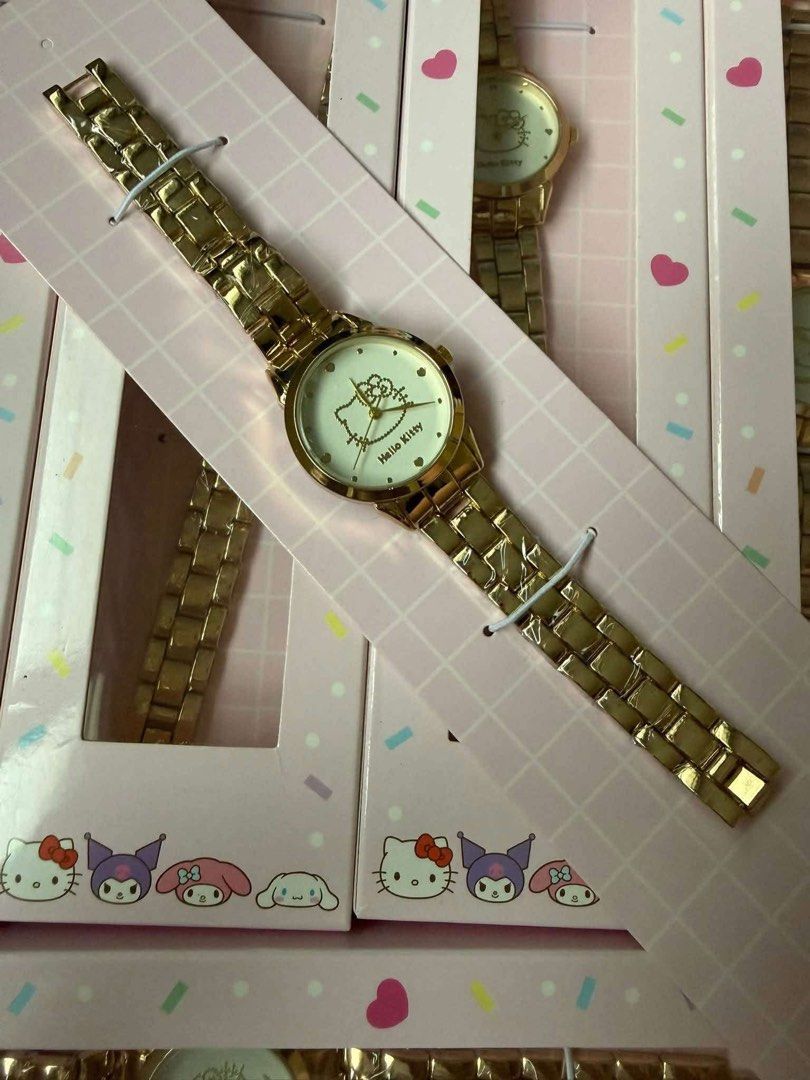 Hello Kitty Gold Metal Link Watch (Category: Women's Watches) located in Manila. Submitted by janetecson05 (Listing ID 1467633330, Image 1). Description: - Gold-tone metal link watch with Kitty dial face - Polished round case and finish links - Mounted on an adorable pink grid packaging card - Features popular Sanrio characters: Kuromi, My Melody, and Cinnamoroll - Perfect accessory or gift for Sanrio fans.