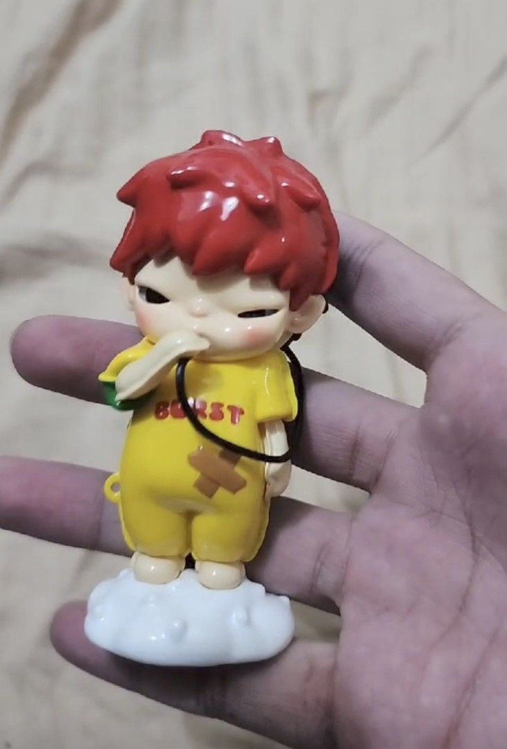 HIRONO: Reshaping Series (Category: Character Goods) located in Pasig City. Submitted by cetleo (Listing ID 1467724515, Image 1). Description: - Collectable figure keychain with a unique reversible design - Features bright red and blue hair options - Side A: Yellow outfit with "BURST" lettering and a bandage - Side B: Green and yellow outfit with "KIROMO" near a heart shape - Stands on a cute white cloud-shaped base - Comes with a convenient blac