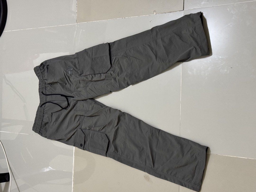 H&M Cargo pants (Category: Joggers) located in Manila. Submitted by ensiithrifter (Listing ID 1467745392, Image 1). Description: Upgrade your streetwear and utility wardrobe with these H&M Grey Nylon Utility Cargo Joggers. Crafted from a lightweight, smooth nylon-feel woven fabric, these pants feature an embroidered tone-on-tone H&M logo on the left leg for a subtle branding detail. Color: Charcoal / Warm Slate Grey Material: Smooth, lightweight 