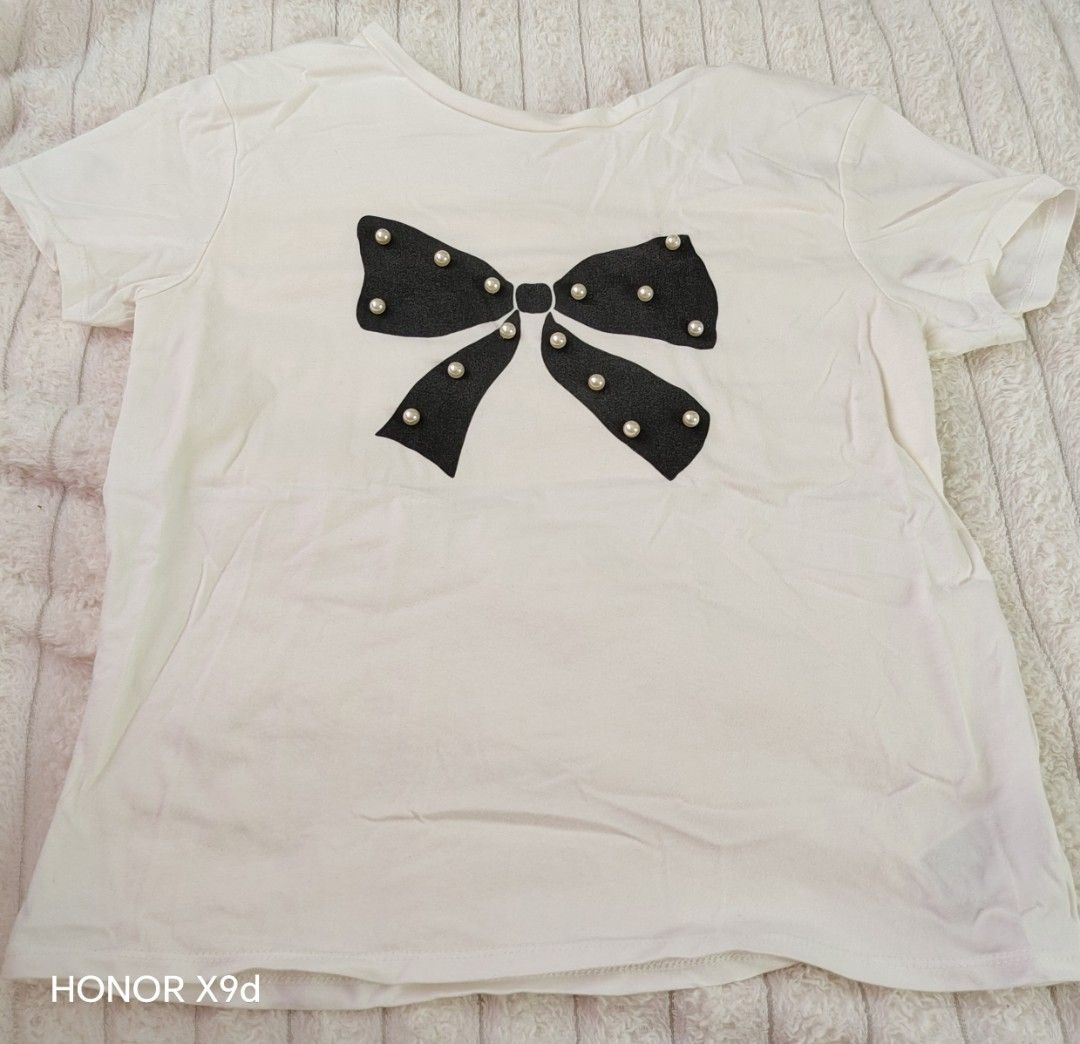 H&M cute kids top (Category: Shirts) located in Mabalacat. Submitted by Jackikay.PreLoved (Listing ID 1467618612, Image 1). Description: - Brand: H&M - Color: White with black bow and pearl details - Size: EUR 134/140 (approx. 8-10 year s) - Material: Comfortable cotton - Perfect for daily casual wear or outings.