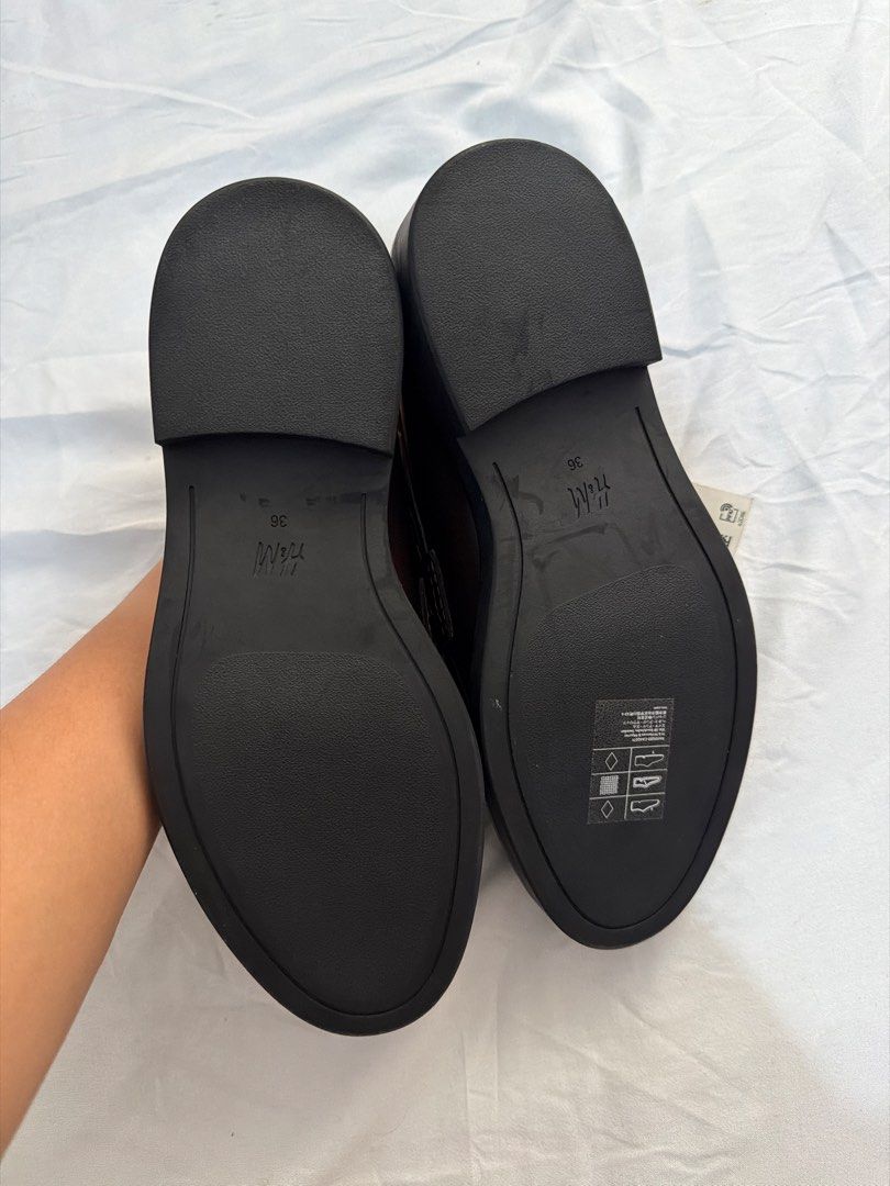 H&M Dark Brown Chain Loafers Size 36 (Category: Loafers) located in Pasig City. Submitted by _missdee (Listing ID 1467669107, Image 2). Description: - Brand: H&M - Style: Dark brown loafers with chunky gold chain detail and thick soles - Size: 36 (printed on inner sole) - Condition: Brand new, never worn out, store tag still attached - Type: Slip-on.