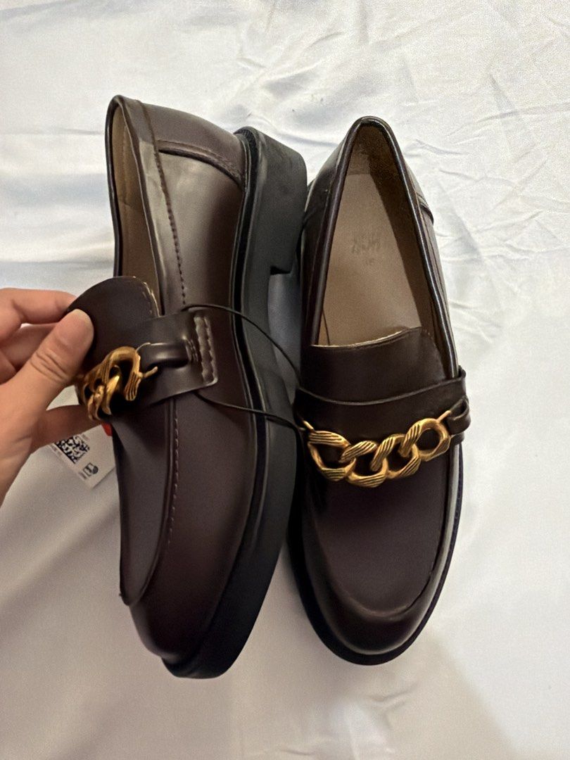 H&M Dark Brown Chain Loafers Size 36 (Category: Loafers) located in Pasig City. Submitted by _missdee (Listing ID 1467669107, Image 3). Description: - Brand: H&M - Style: Dark brown loafers with chunky gold chain detail and thick soles - Size: 36 (printed on inner sole) - Condition: Brand new, never worn out, store tag still attached - Type: Slip-on.