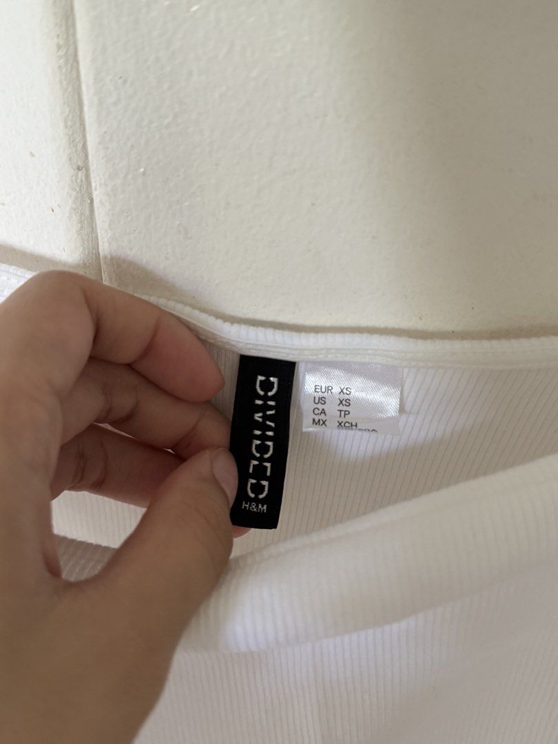 H&M Divided White Eyelet Ruffle Sleeve Crop Top (Category: Blouses) located in Iloilo. Submitted by trixiaaa18 (Listing ID 1467623261, Image 2). Description: - Brand: H&M Divided - Size: XS - Color: Clean White - Material: Stretchy ribbed fabric - Design: Square neckline with cut-out flower eyelet ruffles on sleeves - Condition: Excellent, clean.