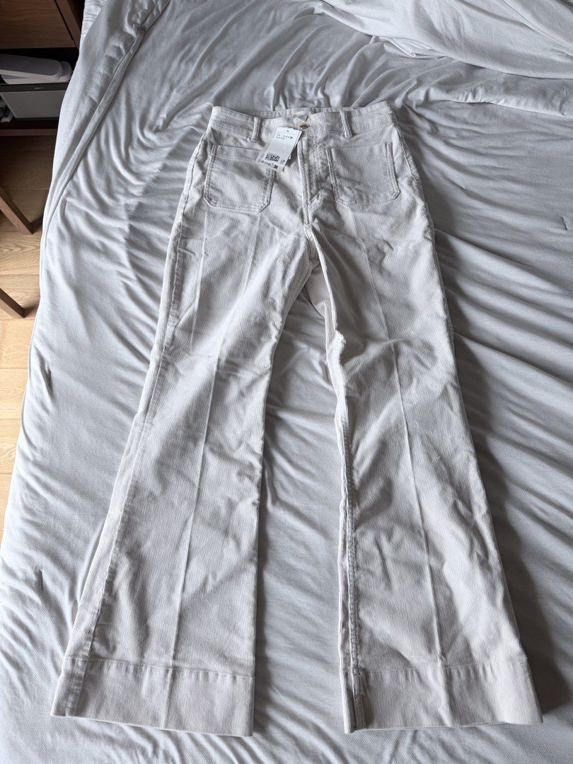 H&M Flared Corduroy Pants size 38 (Category: Jeans) located in Cebu City. Submitted by calligraphybyden (Listing ID 1467627731, Image 2). Description: The specific design features a high-rise waist, prominent 70s-inspired front patch pockets, a visible top-button zip fly, front creasing lines, and a distinct flare from the knee down to the hem..