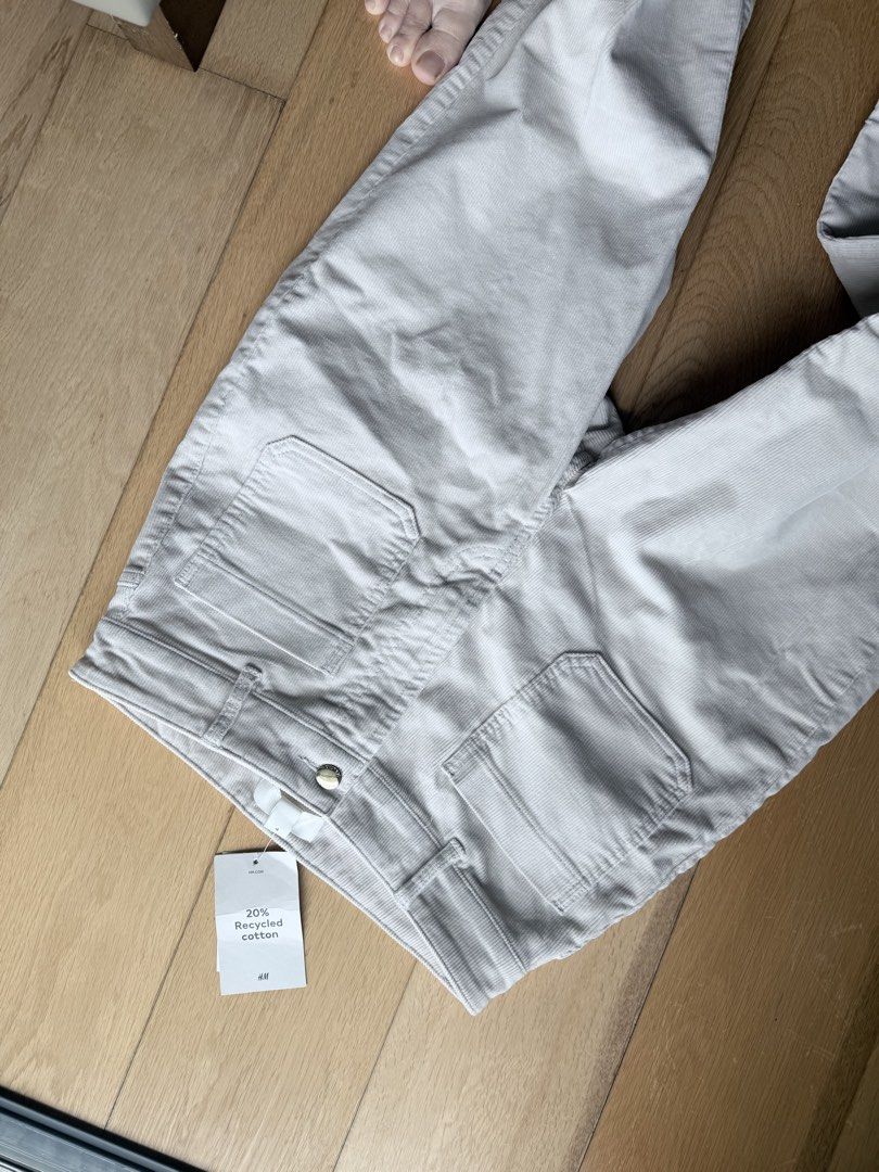 H&M Flared Corduroy Pants size 38 (Category: Jeans) located in Cebu City. Submitted by calligraphybyden (Listing ID 1467627731, Image 3). Description: The specific design features a high-rise waist, prominent 70s-inspired front patch pockets, a visible top-button zip fly, front creasing lines, and a distinct flare from the knee down to the hem..