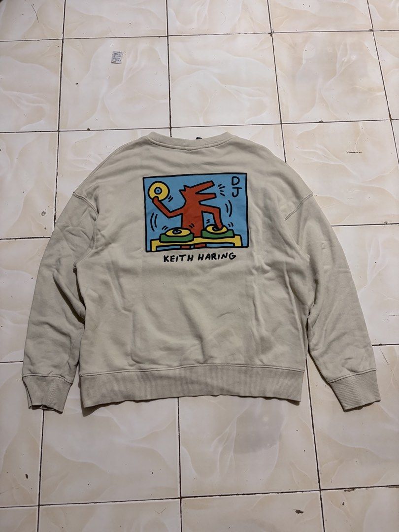 H&M x Keith Haring Oversized DJ Sweatshirt Size L (Category: Coats, Jackets and Outerwear) located in Davao. Submitted by chazethrift (Listing ID 1467739314, Image 1). Description: - Brand: H&M - Item: Oversized crewneck sweatshirt - Color: Light beige - Size: Large - Design: Keith Haring DJ graphic on the back with text on the front ('What do i do with my spare time? What spare time?') - Fit: Comfortable slouchy fit with ribbed cuffs and hem - C