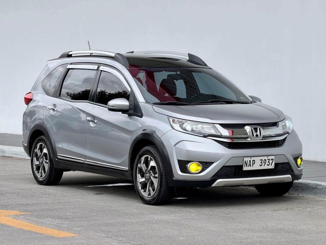 Honda BR-V V Navi Auto (Category: Used Cars) located in Manila. Submitted by quality_cars (Listing ID 1467671370, Image 2). Description: FOR SALE! Honda BRV V Navi 2018 AT Automatic CVT transmission 80k original mileage Top of the line unit 2din navigation head unit Push start engine Auto fold side mirror Newly detailed LED headlights / foglights Thick Yokohama Tires (2024/25 prod) Climate aircon control / dual aircon Medium tint All lights worki