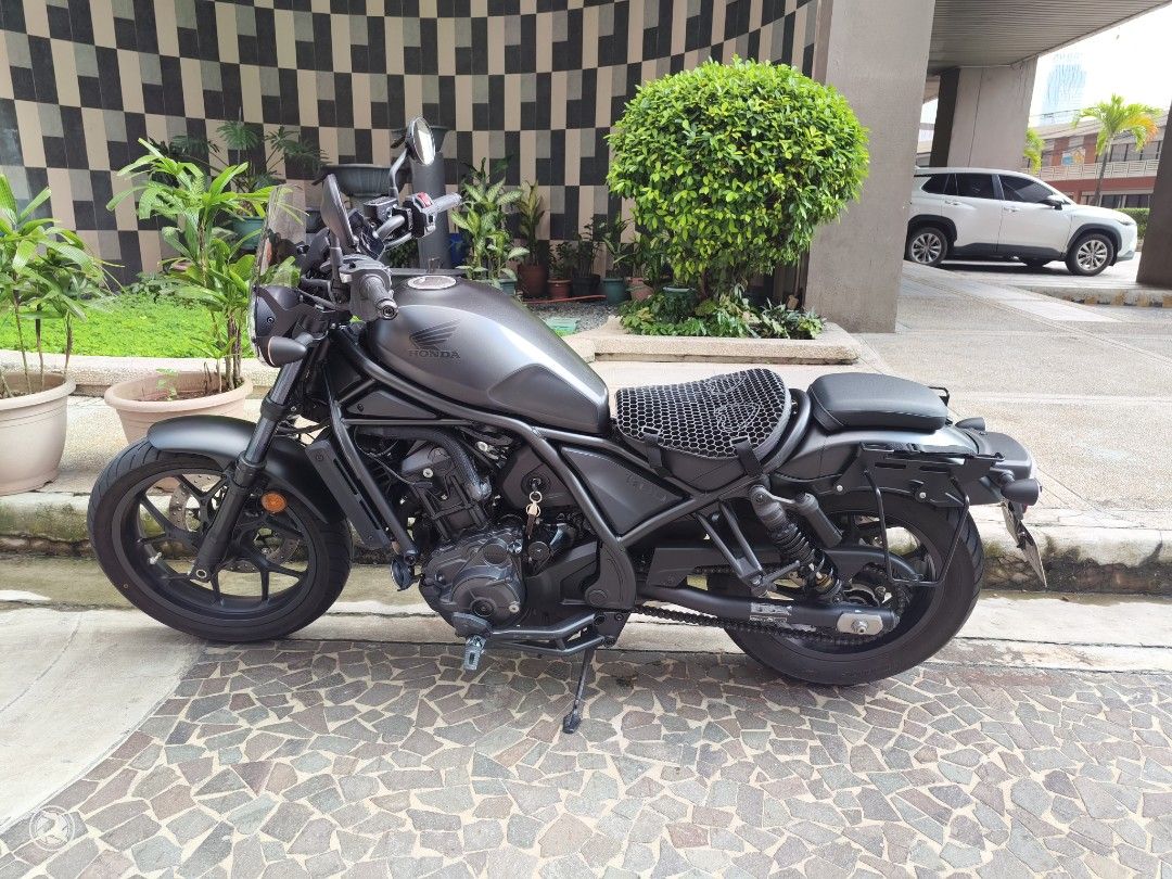Honda Rebel 1100 DCT (Category: Motorbikes for Sale) located in Mandaluyong City. Submitted by ryancab2026 (Listing ID 1467730978, Image 1). Description: Honda Rebel 1100 cruiser motorcycle. 12xxx km Matte black finish throughout. Puig windshield rear luggage rack mount Clean bodywork, well maintained. No to open deed of sale.