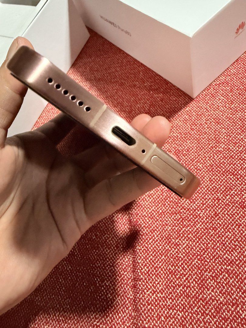 Huawei Pura 80 (Category: Huawei) located in Mandaluyong City. Submitted by gee028 (Listing ID 1467719797, Image 3). Description: - Brand/Model: Huawei Pura 80 - Color: Frosted Gold - Design: Premium metallic flat frame with a distinctive triangular triple-camera module (XMAGE technology) - Ports & Build: Clean bottom layout with USB-C port, speaker grille, and SIM tray; slim and modern profile - Perfect for daily use, photography, and stylish te