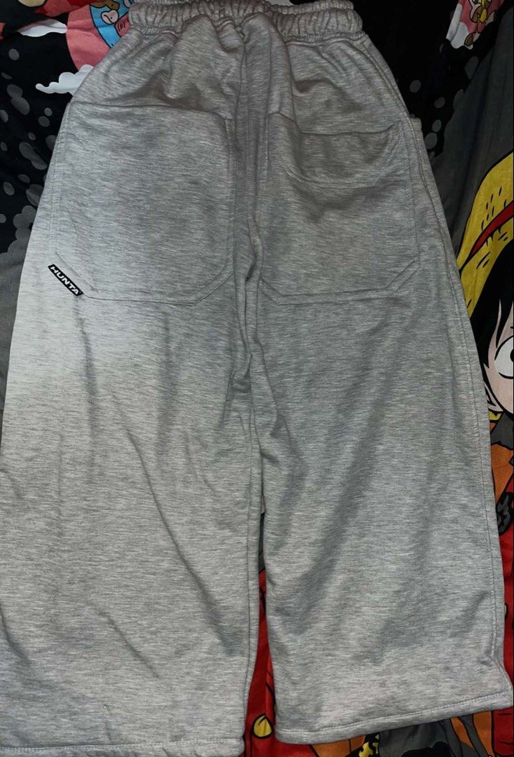 HUNTA Grey Sweatpants Casual Pants (Category: Joggers) located in Manila. Submitted by xlyssaa_20 (Listing ID 1467795459, Image 1). Description: - Brand: HUNTA - Color: Heather Grey - Fit: Relaxed, soft, and comfortable for daily wear - Waistband: Elastic with an adjustable drawstring - Pockets: Two convenient back patch pockets - Details: Small signature branded tag on the left back pocket.