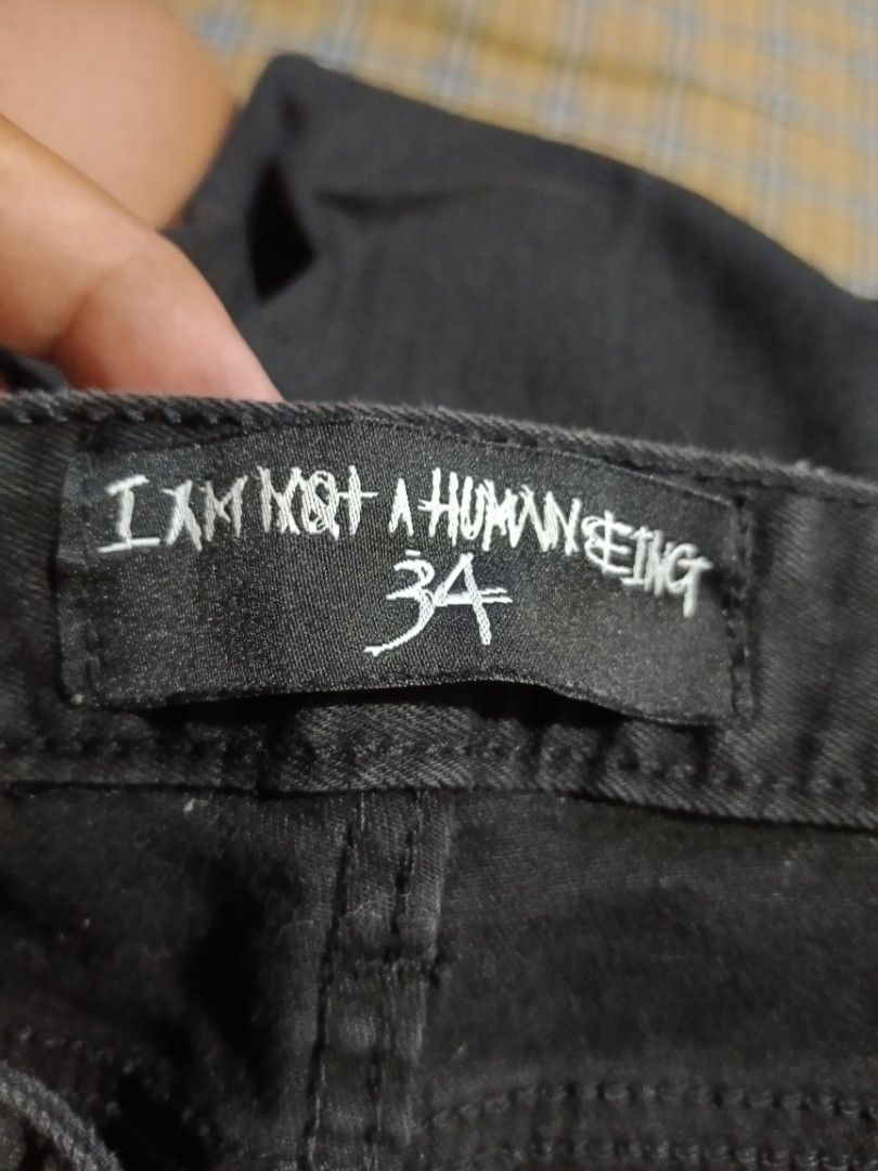 I Am Not A Human Being Graphic Black Jeans (Category: Jeans) located in General Santos City (Dadiangas). Submitted by freehorse.5f2a61 (Listing ID 1467651576, Image 3). Description: - Brand: I Am Not A Human Being - Item: Black Denim Jeans - Size: 34 - Material: 98% Cotton, 2% Polyurethane (Made in Korea) - Design details: Graphic prints on front thighs, text prints on lower legs, and D-ring on back pocket - Authenticity: Includes branded buttons