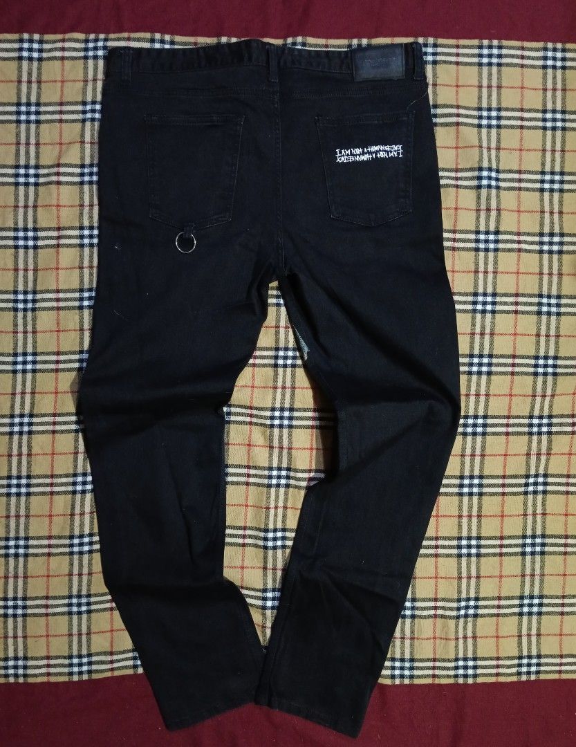 I Am Not A Human Being Graphic Black Jeans (Category: Jeans) located in General Santos City (Dadiangas). Submitted by freehorse.5f2a61 (Listing ID 1467651576, Image 2). Description: - Brand: I Am Not A Human Being - Item: Black Denim Jeans - Size: 34 - Material: 98% Cotton, 2% Polyurethane (Made in Korea) - Design details: Graphic prints on front thighs, text prints on lower legs, and D-ring on back pocket - Authenticity: Includes branded buttons