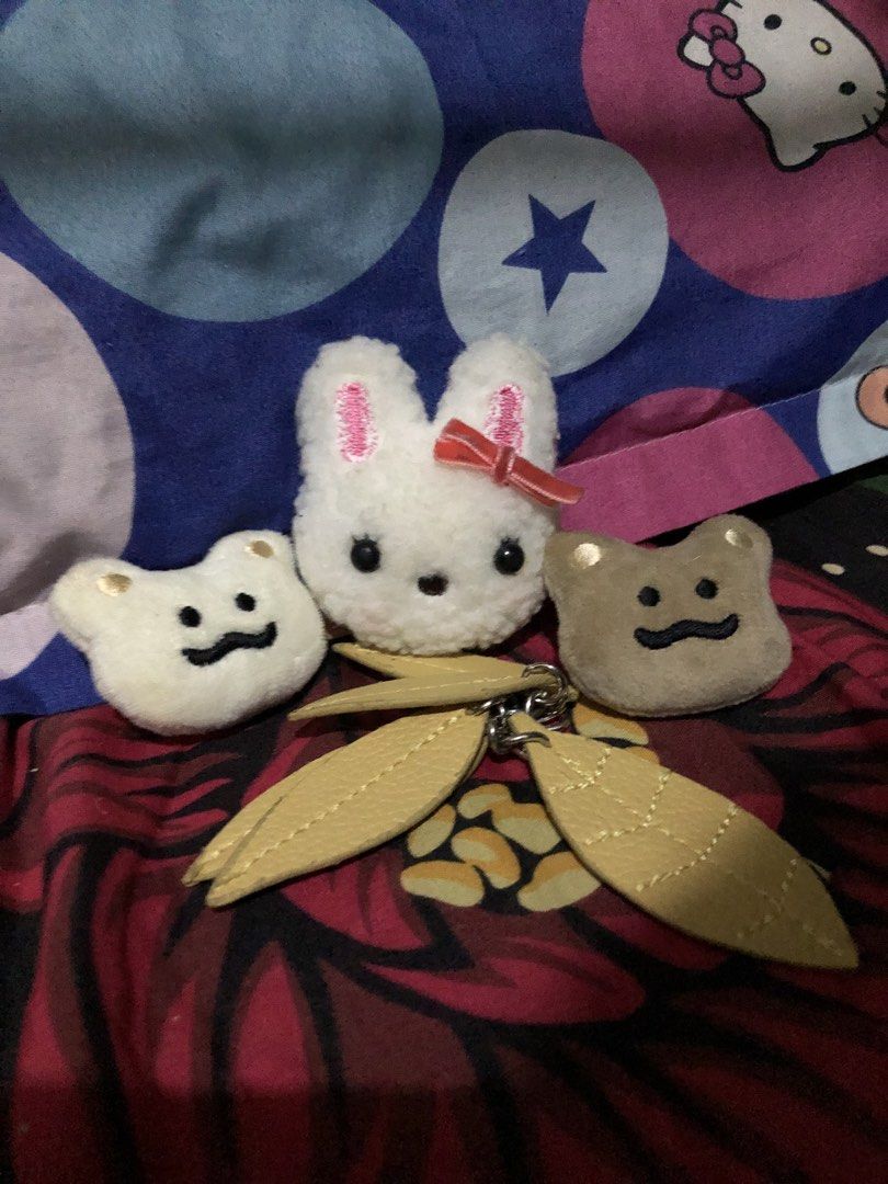 Imported Japan Plush Pins & Leaf Keychain Charm — Set (Category: Charms) located in San Juan, La Union. Submitted by declutteringog7 (Listing ID 1467629560, Image 3). Description: 🐰 Cute Plush Pins & Leaf Charm — Set ₱200 Category: Accessories > Charms & Pins Includes: • 1 Bunny plush pin — soft fabric, with red ribbon bow • 2 Bear/toast face plush pins — cream & brown • 1 Yellow leaf bag charm keychain — faux leather leaves with lobster clasp D