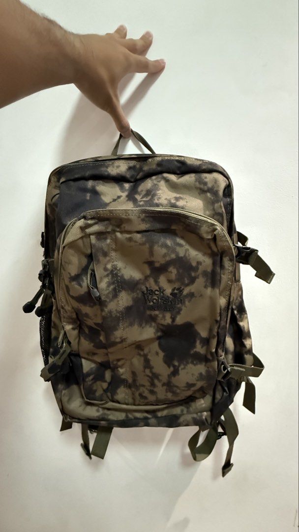 Jack Wolfskin Berkeley Camo Backpack (Category: Backpacks) located in Quezon City. Submitted by kobeeeee_12 (Listing ID 1467737011, Image 1). Description: - Brand: Jack Wolfskin Berkeley - Design: Camo green tie-dye pattern - Compartments: Multiple zippered compartments for easy organization - Interior Features: Built-in laptop sleeve divider in the main compartment, plus pen slots and a key clip in the front pocket - Comfort: Padded shoulder str