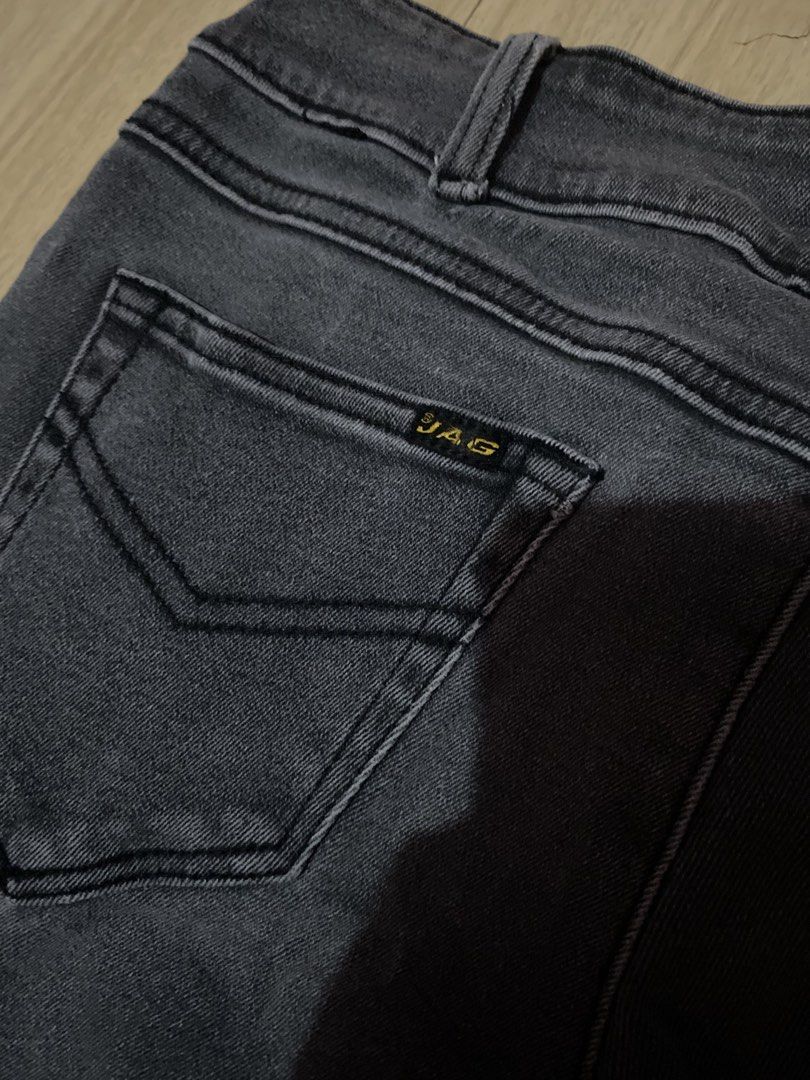 JAG Charcoal Grey Flare Jeans (Category: Jeans) located in Tanauan. Submitted by rie098 (Listing ID 1467761687, Image 3). Description: - Brand: JAG - Waist - 29 - Color: Charcoal grey / Washed black - Design: Unique curved panel seams on front legs with a flared hem cut - Details: Standard button and zipper fly, functional front and back pockets, belt loops - Branding: Authentic brown leather patch on the back waistband.