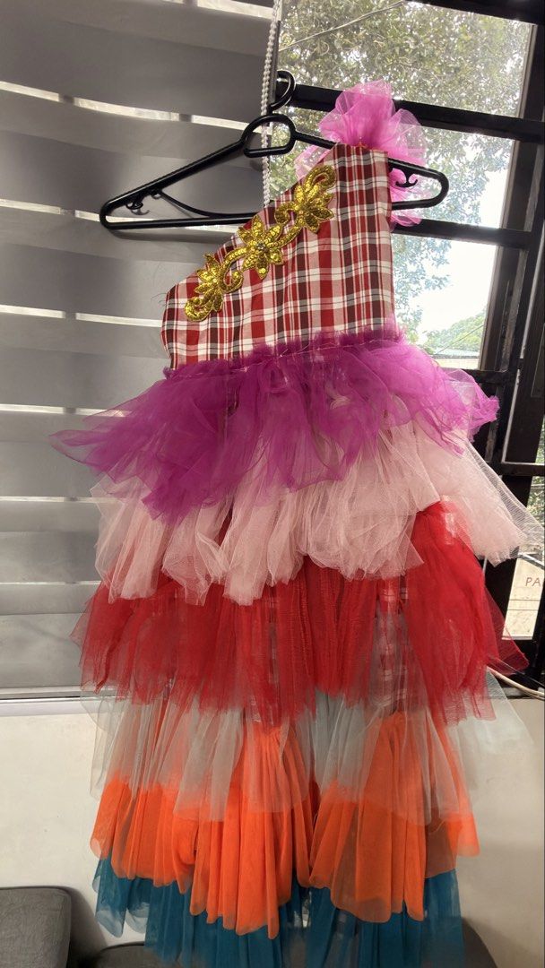 Jamaica costume (Category: Babies & Kids Fashion) located in Mandaluyong City. Submitted by sentfromheaven (Listing ID 1467836765, Image 3). Description: - Vibrant multi-layered party tutu dress - Red and white plaid one-shoulder bodice with gold floral sequin appliques - Cute pink tulle flower detail on the shoulder strap - Colorful tulle tiers in purple, light pink, red, grey, bright orange, and dark teal - Perfect for birthdays, parties, and s