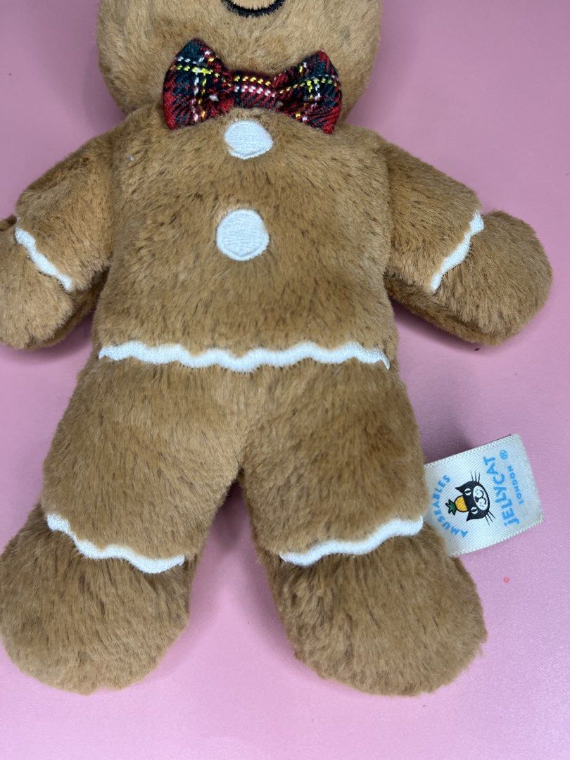 Jellycat Amuseables Gingerbread Man Plush Toy (Category: Plushies & Soft Toys) located in Caloocan City. Submitted by snapshop_ph (Listing ID 1467645026, Image 3). Description: - Authentic Jellycat Amuseables Gingerbread Man plush toy - Super soft brown fur with embroidered face and white icing details - Festive red and green plaid tartan bow tie and two white chest buttons - Original tag still attached - Clean, well-maintained, and from a smoke-
