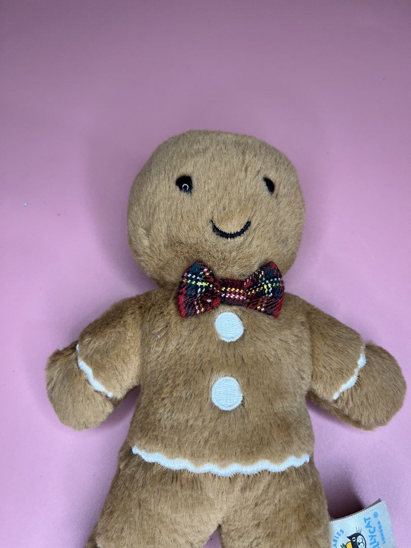 Jellycat Amuseables Gingerbread Man Plush Toy (Category: Plushies & Soft Toys) located in Caloocan City. Submitted by snapshop_ph (Listing ID 1467645026, Image 2). Description: - Authentic Jellycat Amuseables Gingerbread Man plush toy - Super soft brown fur with embroidered face and white icing details - Festive red and green plaid tartan bow tie and two white chest buttons - Original tag still attached - Clean, well-maintained, and from a smoke-