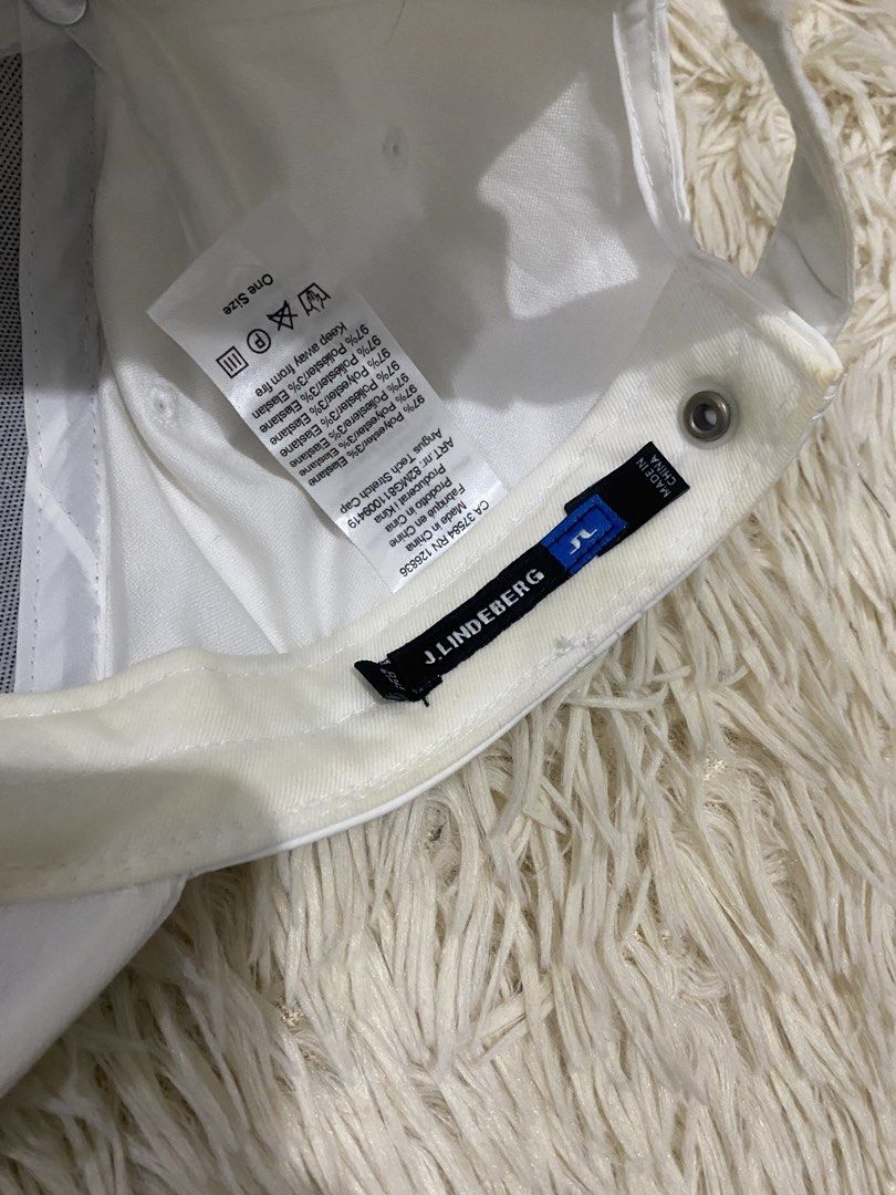 j.lindeberg Angus Tech Stretch Cap White (Category: Caps & Hats) located in Antipolo. Submitted by switchneighborhood (Listing ID 1467739003, Image 3). Description: - Brand: J.Lindeberg - Model: Angus Tech Stretch Cap - Color: Clean White - Logo: Prominent embroidered JL bridge logo on front - Material: 97% polyester, 3% elastane - Closure: Adjustable strapback with branded silver metal hardware - Fit: One size fits most - Condition: Brand new/Gr