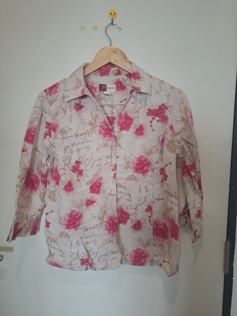 JM COLLECTION 100% LINEN (Category: Longsleeves) located in Manila. Submitted by joanbalde39643 (Listing ID 1467660257, Image 1). Description: This is a women's 100% linen button-down blouse from the brand JM Collection. It features an all-over bright pink watercolor floral pattern layered on top of an ecru/cream background with faint cursive script handwriting graphics.