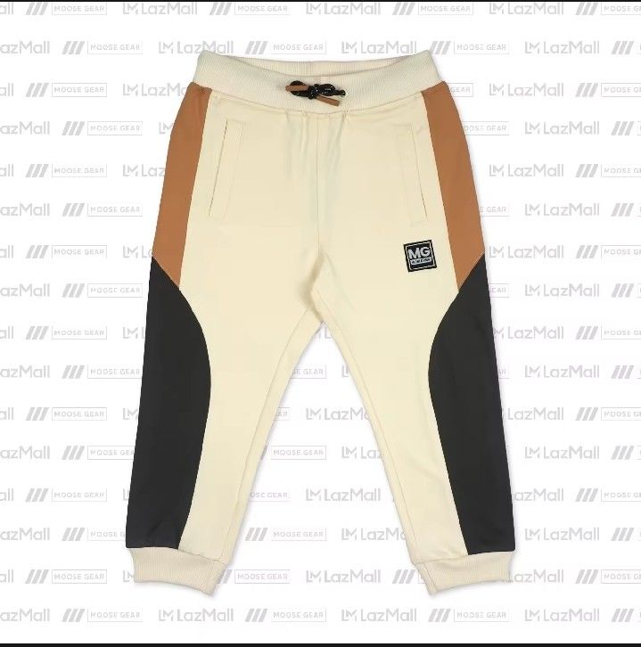 Jogger Pants Moose Gear Brand new (Category: Babies & Kids Fashion) located in Quezon City. Submitted by zabandzycloset (Listing ID 1467687879, Image 2). Description: - Brand: Moose Gear - Size: 12 - Condition: Brand new with tags attached - sign: Cream base with brown upper thigh panels and black lower leg panels - Features: Ribbed waistband with dark drawstring, ribbed ankle cuffs, and two functional side pockets - Accent: Small embroidered MG 
