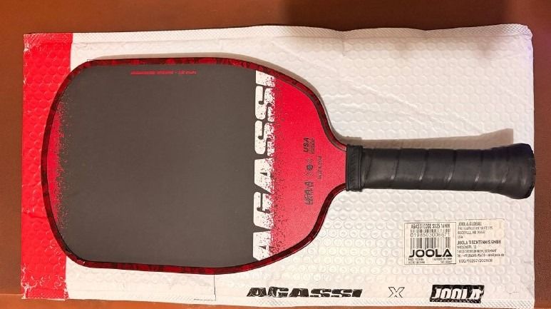 JOOLA Agassi Edge 16mm Pickleball Paddle (Category: Racket and Ball Sports) located in Pasig City. Submitted by hansonmain (Listing ID 1467779806, Image 1). Description: Agassi Edge 16mm - Comes with original packaging and seal from Joola. - Comes with a third-party edge guard from Orange App. - SRP: 6000 online. Bought online from a legit source. Used for only a few months; comes with an edge guard and original packaging + seal. Includes a third