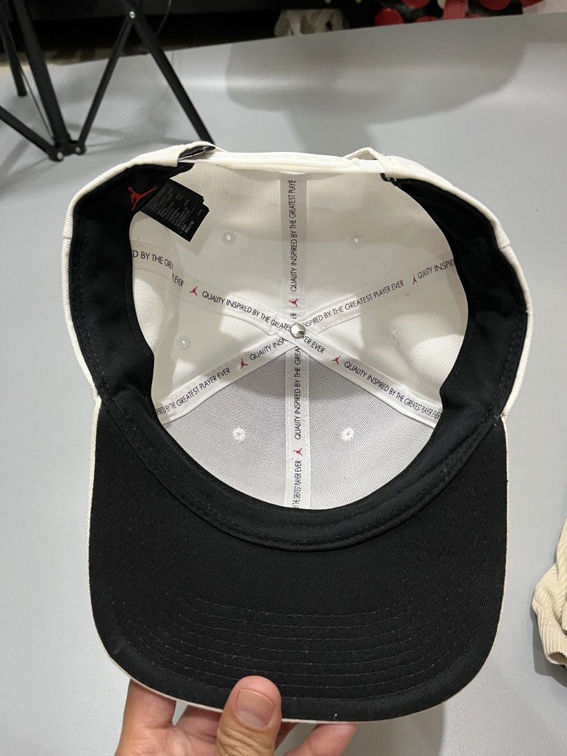 Jordan Jumpman Snapback Cap White Black (Category: Caps & Hats) located in Manila. Submitted by jorgemabelin2001 (Listing ID 1467760788, Image 3). Description: - Color: Clean white with black embroidered Jumpman logo - Fit: Adjustable white plastic strap with Jordan branding at the back - Details: Inner taped seams feature the iconic 'Quality Inspired By The Greatest Player Ever' phrase - Condition: Excellent, crisp structure overall - Perfect fo