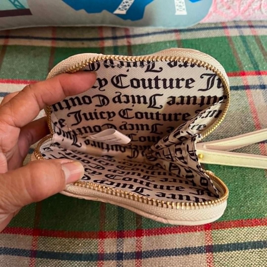Juice Couture White Heart Embossed Wristlet (Category: Purses & Pouches) located in Cebu City. Submitted by islanevaeh85 (Listing ID 1467646902, Image 3). Description: - Brand: Juicy Couture - Color: White with multi-color rhinestone heart embellishment - Design: All-over debossed monogram pattern with zip closure - Features: Matching wrist strap with an extra heart charm and custom logo interior lining - Size: Compact and handy for essentials li