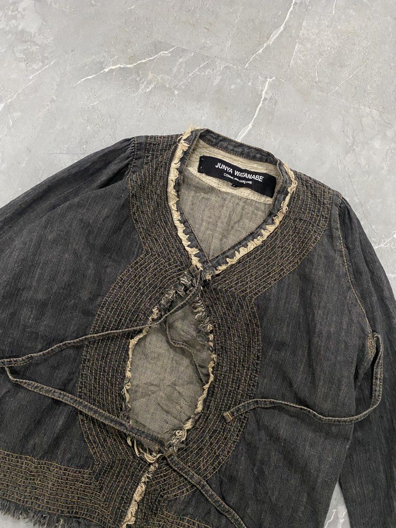 Junya Watanabe Comme des Garçons Denim Jacket AD2004 (Category: Others Tops) located in Santa Maria. Submitted by saintarchive316 (Listing ID 1467642441, Image 2). Description: - Brand/Designer: Junya Watanabe Comme des Garçons (AD2004) - Model: JO-J019 - Size: Medium (M) - Material: 100% Cotton, Made in Japan - Design details: Distressed frayed edges, contrast stitching, and front tie closure - Condition/Style: Unique archive piece with raw coll